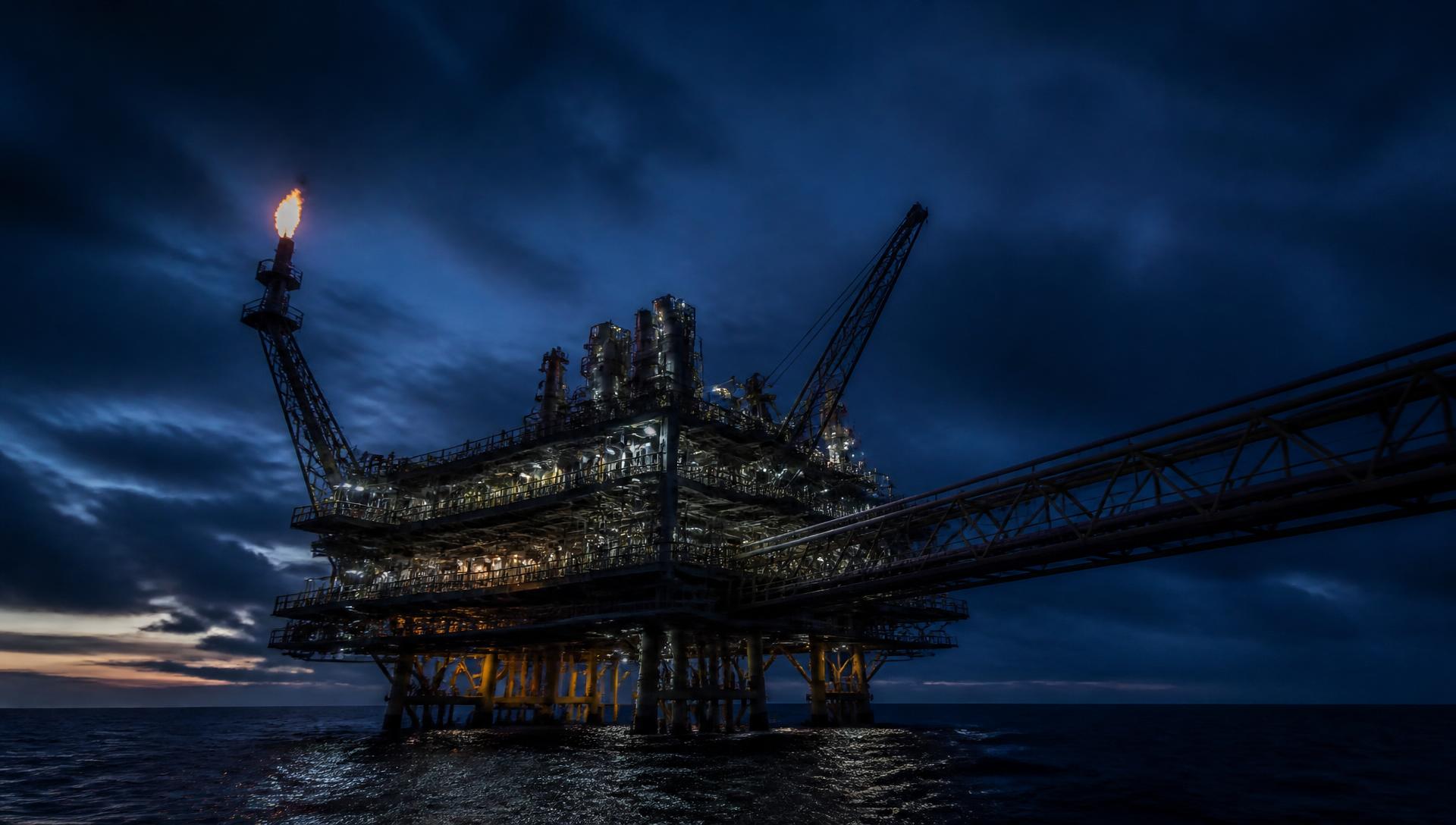 Offshore oil and gas production platform at dusk